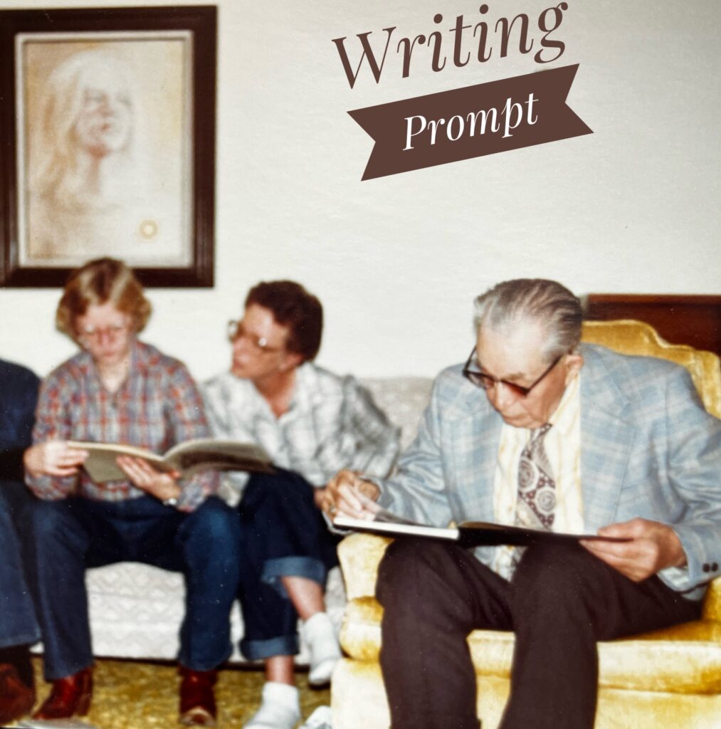 3 people sitting, looking at books